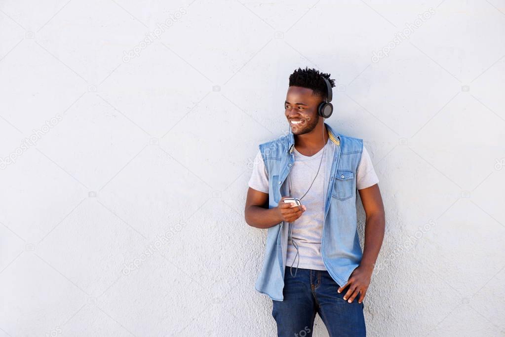 man standing by white wall