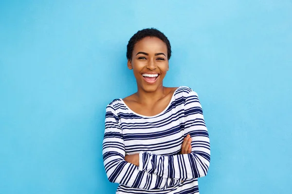 Young black woman against blue wall — Stock Photo, Image