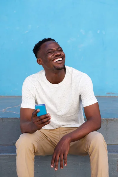 Homem africano segurando telefone celular — Fotografia de Stock
