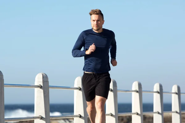 Young man jogging outside — Stock Photo, Image