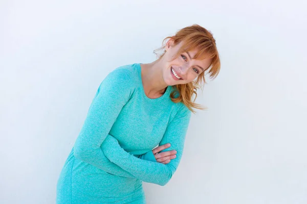 Female runner laughing against wall — Stock Photo, Image