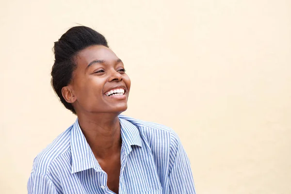 woman laughing against wall