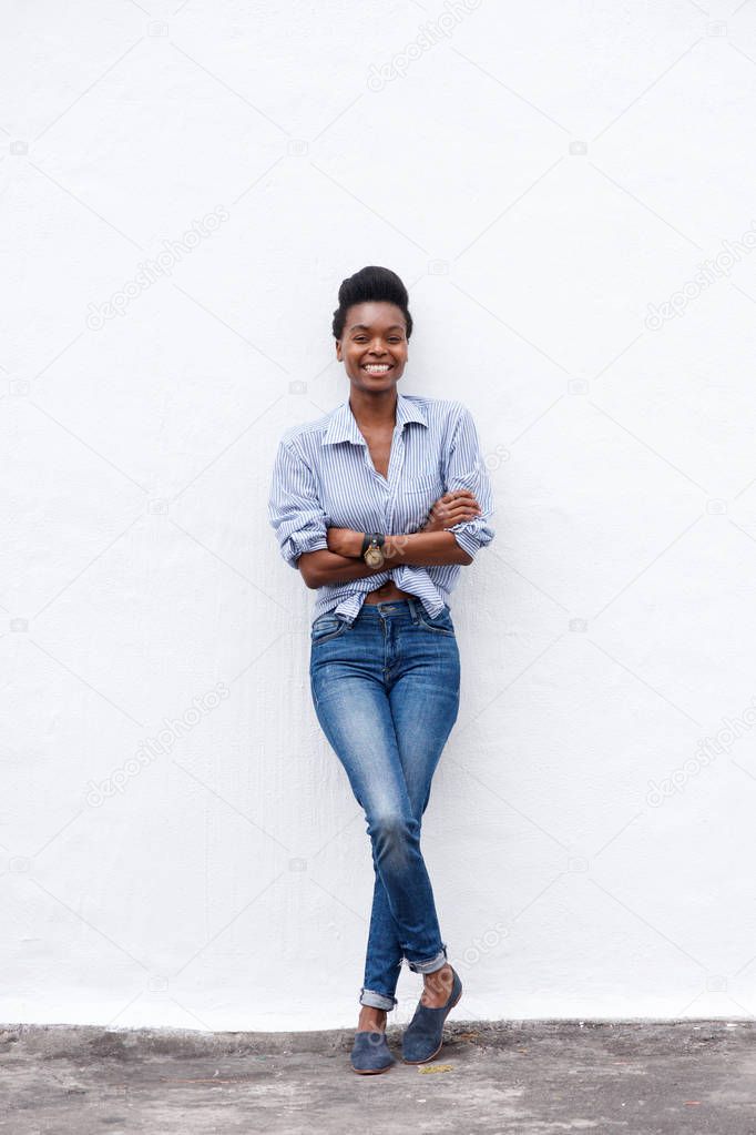 woman smiling against white wall