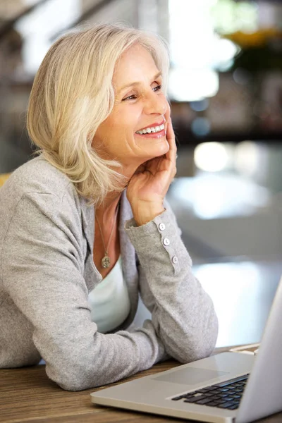 woman smiling by laptop