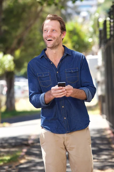 Man walking with cell phone — Stock Photo, Image