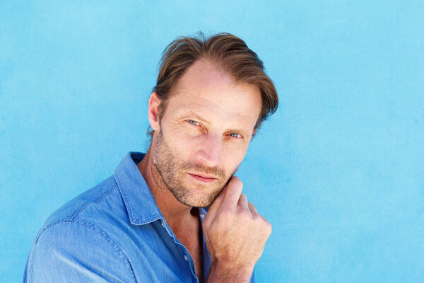 male with hand to chin