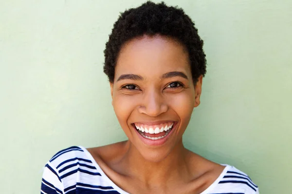 Woman laughing against green background — Stock Photo, Image