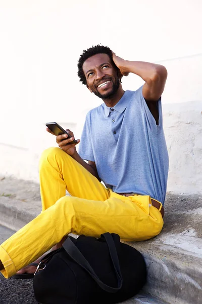 Man sitting and holding phone — Stock Photo, Image