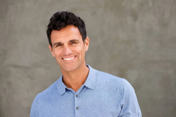 Handsome older man smiling at camera — Stock Photo, Image