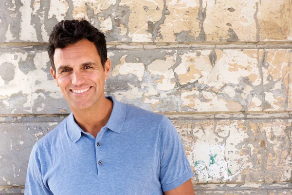 Handsome man in blue shirt looking at camera — Stock Photo, Image