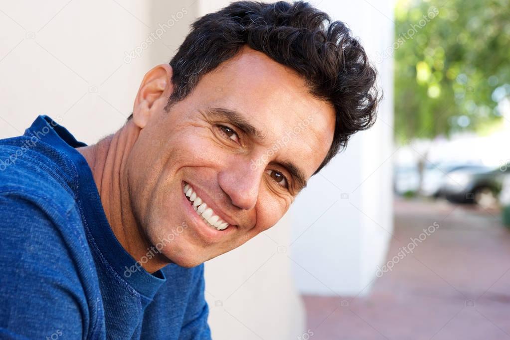 attractive mature man smiling at camera