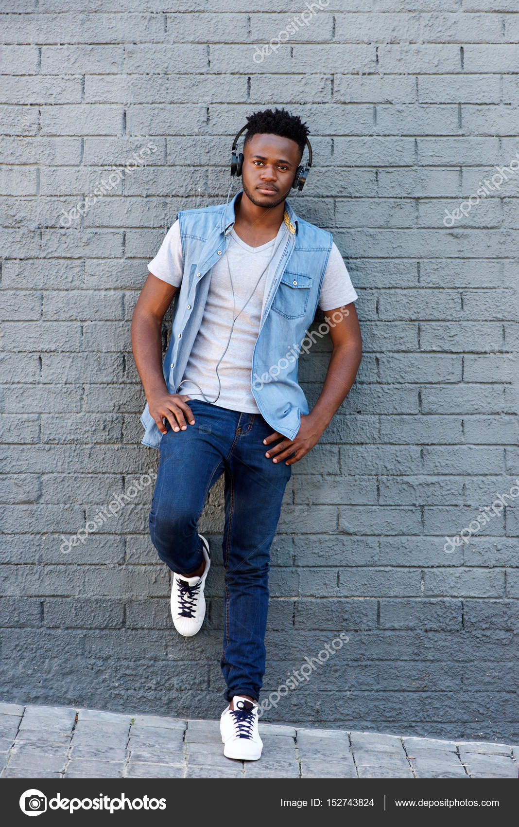 Guy leaning against wall Stock Photo by ©mimagephotos 152743824