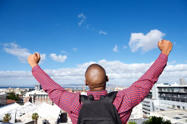 Man with bag raising hands — Stock Photo, Image