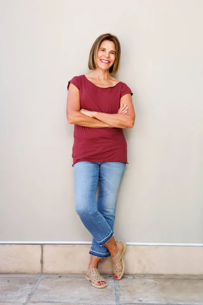 Vrouw leunend tegen muur — Stockfoto