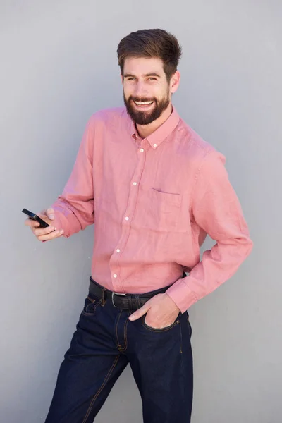 Handsome businessman holding phone — Stock Photo, Image