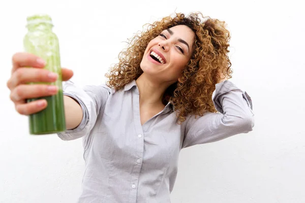 Woman holding bottle of green juice — Stock Photo, Image