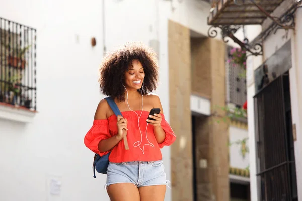 Woman on street with earphones — Stock Fotó