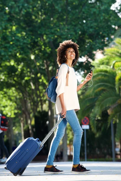 Путешественник ходит с чемоданом и телефоном — стоковое фото