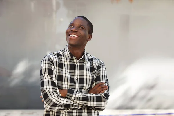 Portrait Happy Young Black Man Arms Crossed Standing Looking Away — Stock Photo, Image