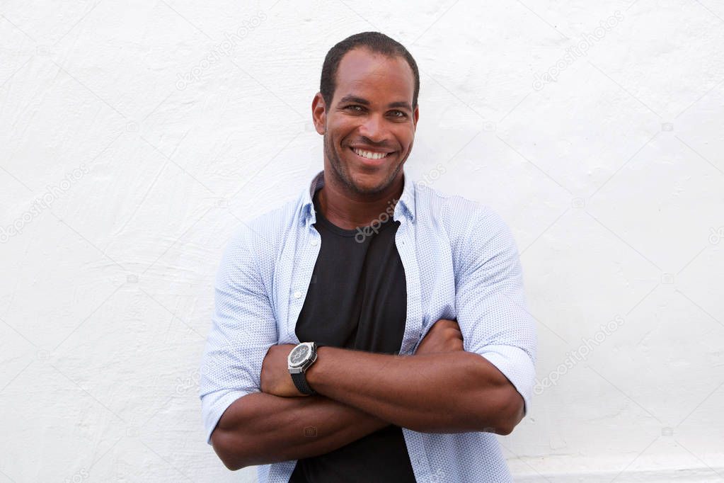 Close up portrait of handsome man laughing standing with arms crossed isolated on white