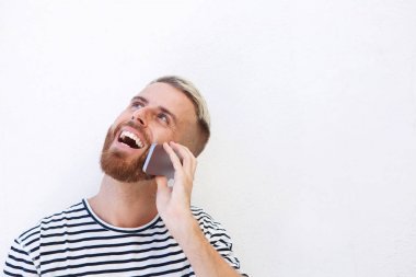 Beyaz arka plan karşı cep telefonuyla konuşan mutlu genç adam portresi kapatın 