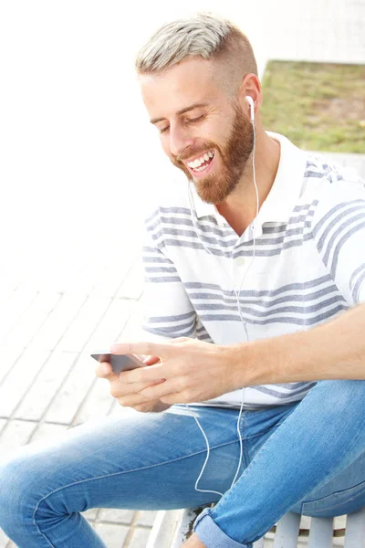 Portrait Happy Young Man Sitting Mobile Phone Earphones — Stock Photo, Image