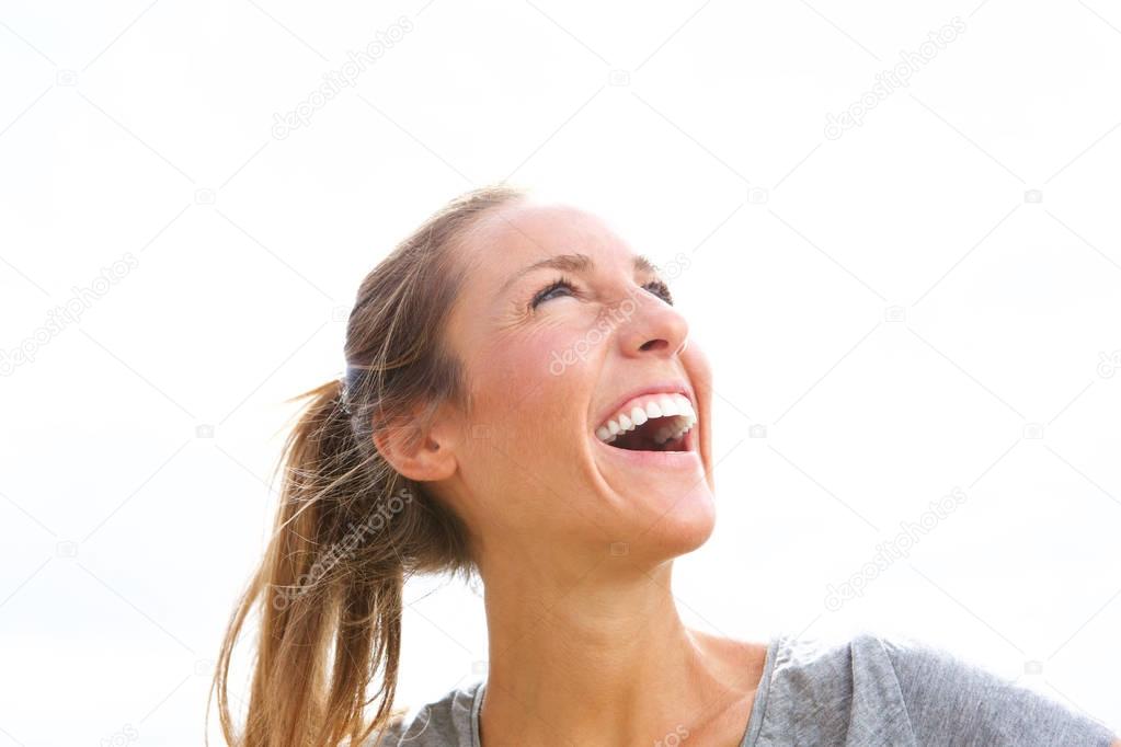 Portrait of happy young beautiful woman laughing outside