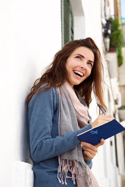 Portrait Cheerful Young Woman Laughing Outdoors Writing Book — Stok Foto