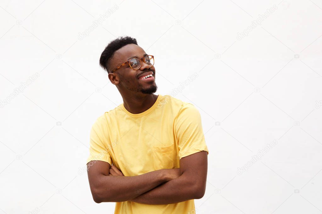 Portrait of a handsome young black man smiling with glasses against white background
