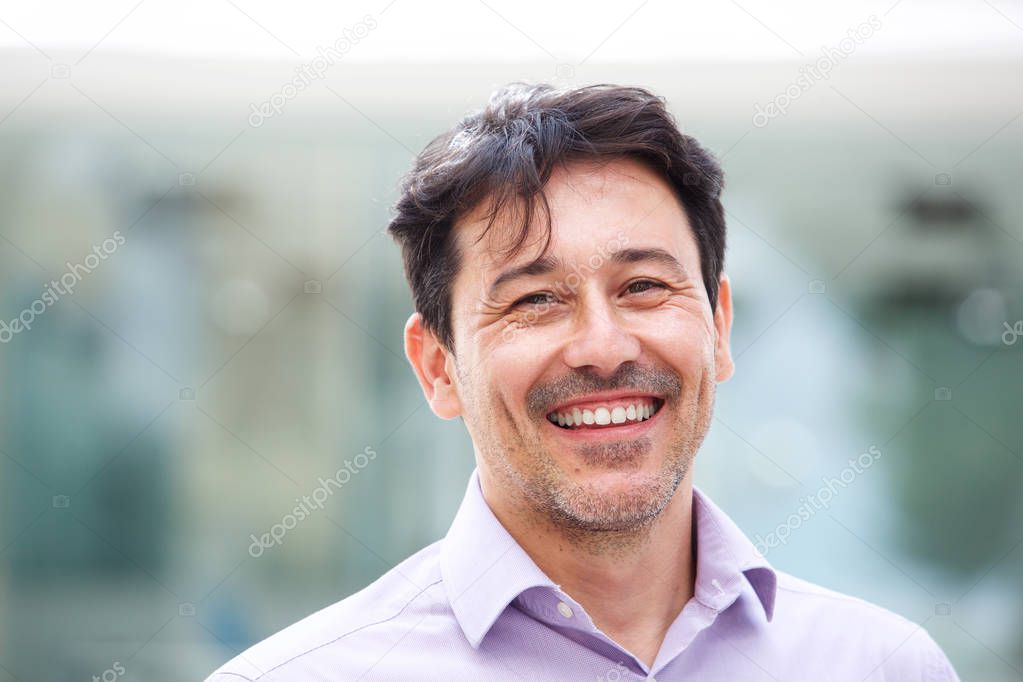 Close up portrait of relaxed mature man smiling outdoors