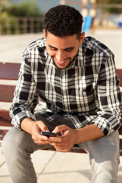 快乐年轻的北非男子的肖像看手机 — 图库照片