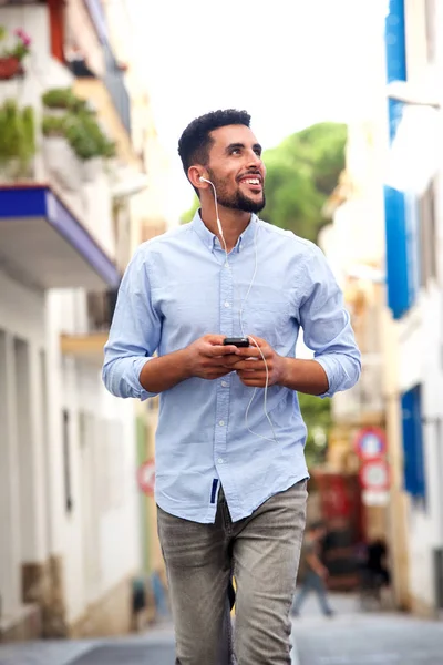 Portrait Smiling Young North African Man Walking Street Cellphone Headphones — Stock Photo, Image
