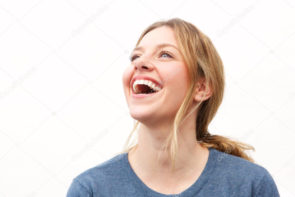 Close up portrait of attractive young woman laughing against white background
