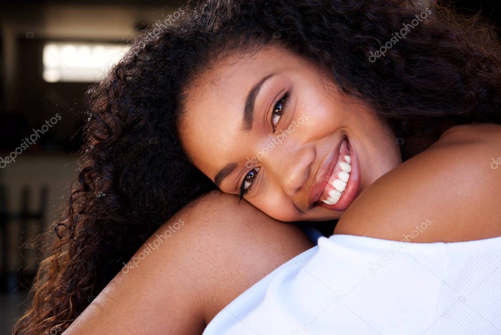 Close up portrait of attractive young black woman smiling 