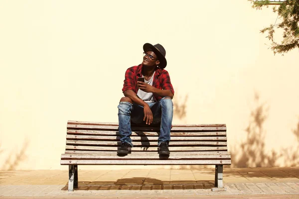 Portrait Cool African Guy Hat Sitting Bench Street — Stock Photo, Image