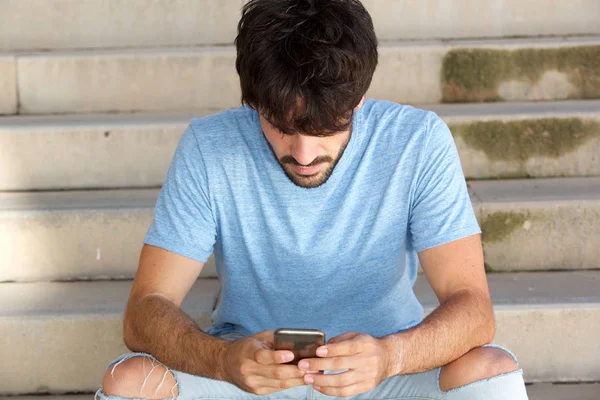 Portrait Young Man Beard Sitting Looking Cellphone — Stok Foto