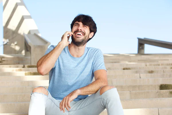 Portrait of happy man talking on mobile phone