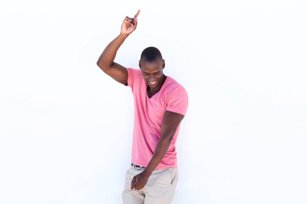 Portrait of cheerful african american man pointing fingers at copy space on white background