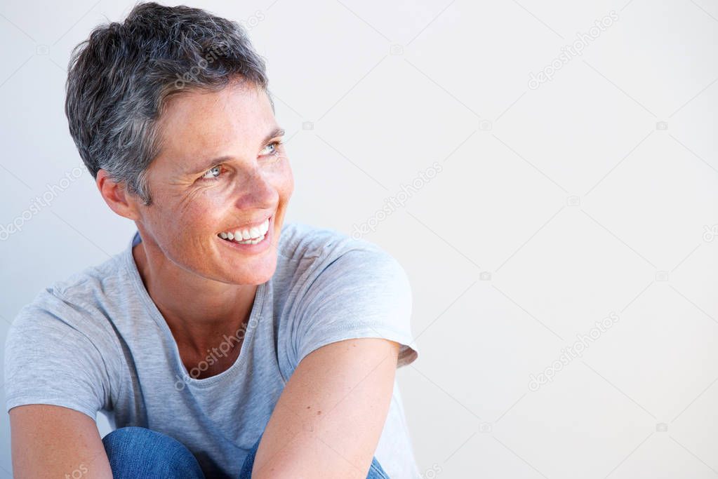 Close up portrait of beautiful older woman smiling against white background