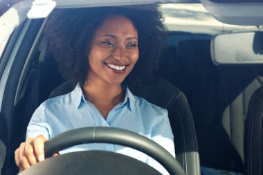 Bir araba ve gülümseyen mutlu genç Afro-Amerikan kadın portresi