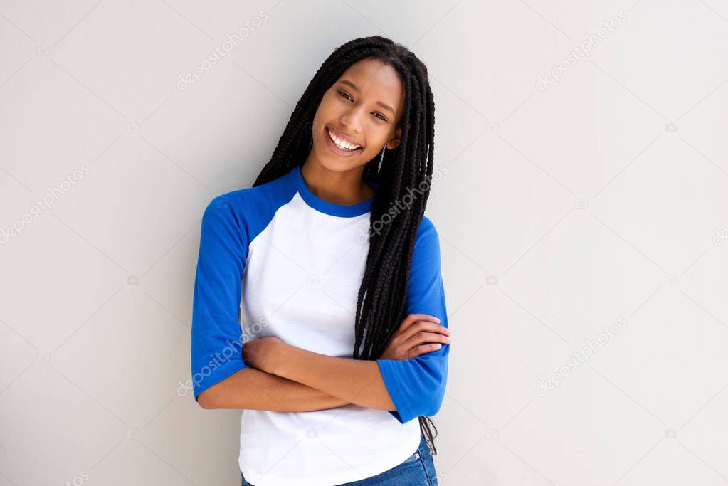 Portrait of cool young african girl standing with arms crossed