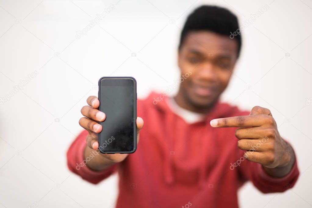 Close up african american man hands holding mobile phone and pointing to screen