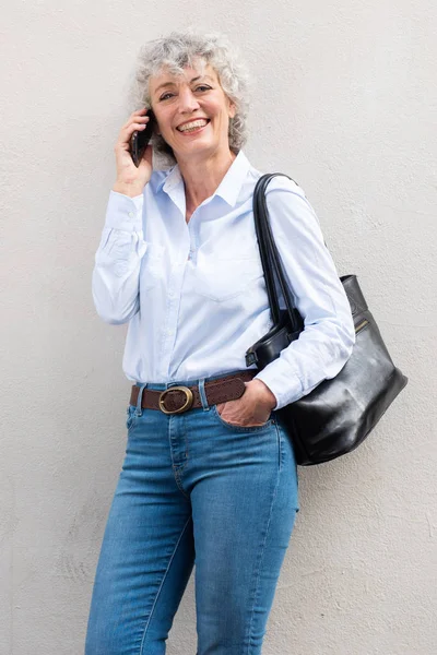 Portrait Smiling Middle Aged Woman Talking Cellphone White Wall — Stock Photo, Image