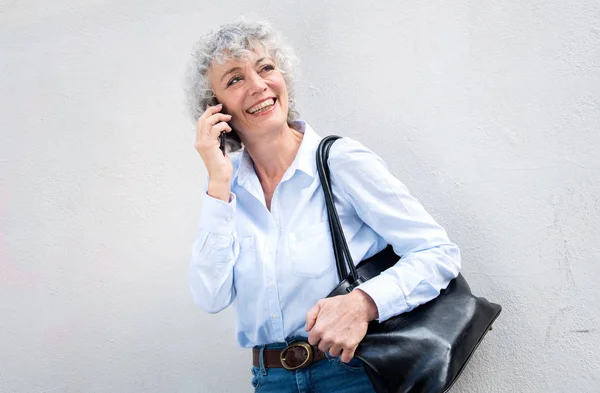 Portrait Happy Middle Aged Woman Talking Cellphone White Wall — Stock Photo, Image