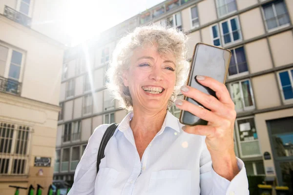 Närbild Porträtt Leende Äldre Kvinna Tittar Mobiltelefon Medan Staden Solig — Stockfoto
