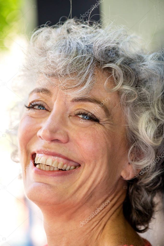 Close up side portrait of happy older woman 