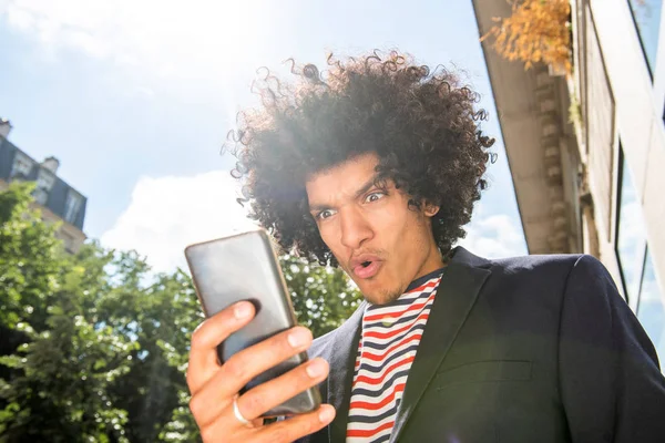Close Portret Zaskoczony Młody Arabski Facet Afro Włosy Patrząc Telefon — Zdjęcie stockowe