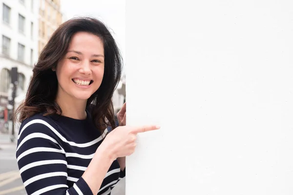 Portrait Smiling Young Woman Pointing White Background Copy Space — Stock Photo, Image