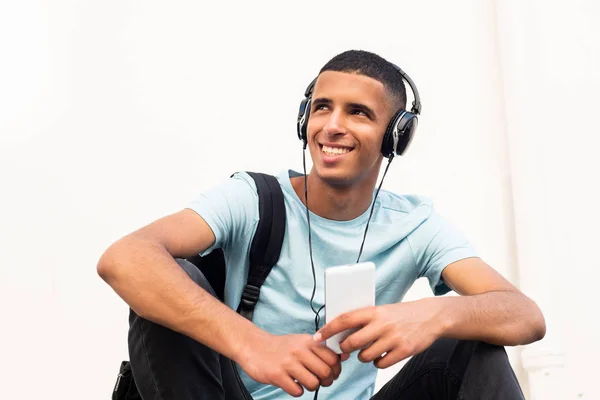 Portrait Young Happy North African Man Sitting White Wall Listening — Stock Photo, Image