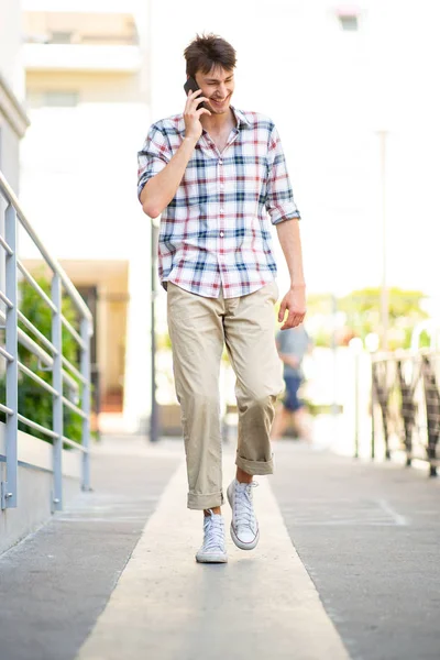 Full Length Portrait Happy Young Man Walking Talking Mobile Phone — Stock Photo, Image